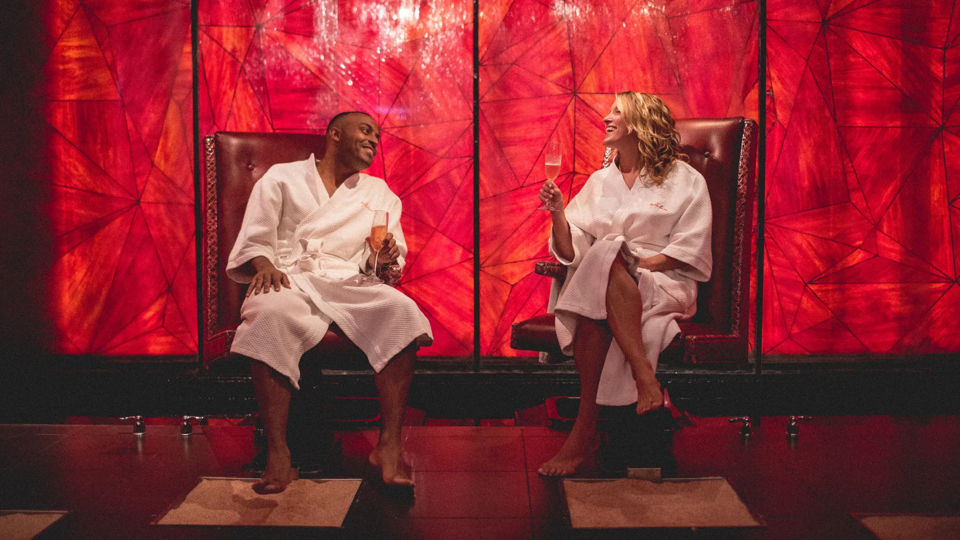 Couple in white robes sitting in salt room at Reflections Spa