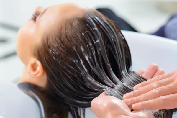 Deep conditioning treatment on clients hair.
