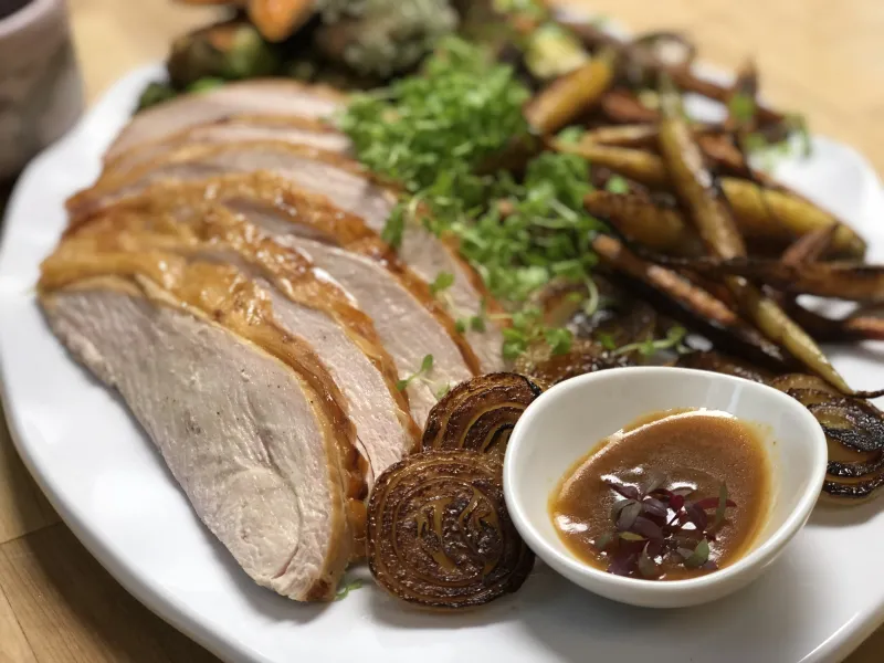 Thanksgiving plate with sliced turkey, gravy, and vegetables