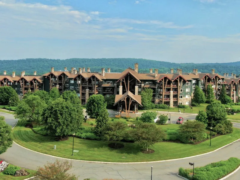 Grand Cascades Lodge front view with mountains in back.